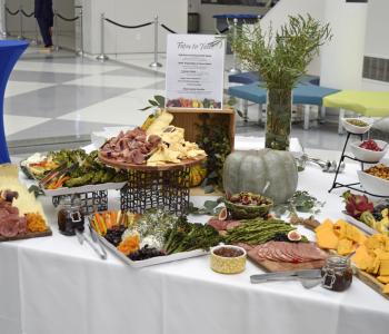 Charcuterie foods plated on a table, with a "Farm to Table" theme