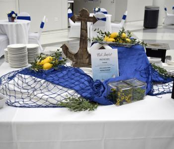 Table set up for a "Fish Market" theme, including a fish net, lemons, and an anchor prop