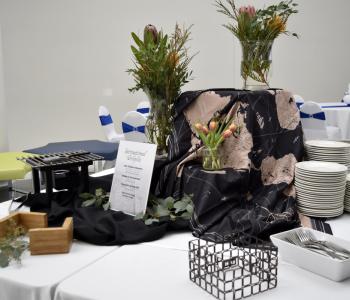 Table set up for an "International Delights" theme, including a tablecloth with a map on it